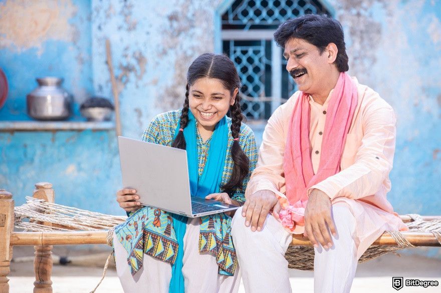 What is Jio Crypto: an Indian father and his daughter using a laptop.