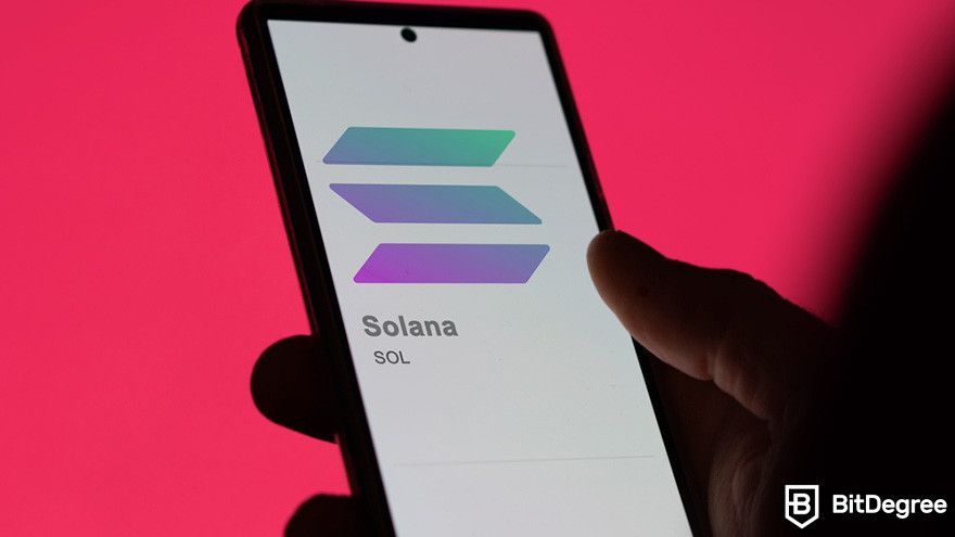 What is Render crypto: a person holding a mobile phone displaying Solana's logo.