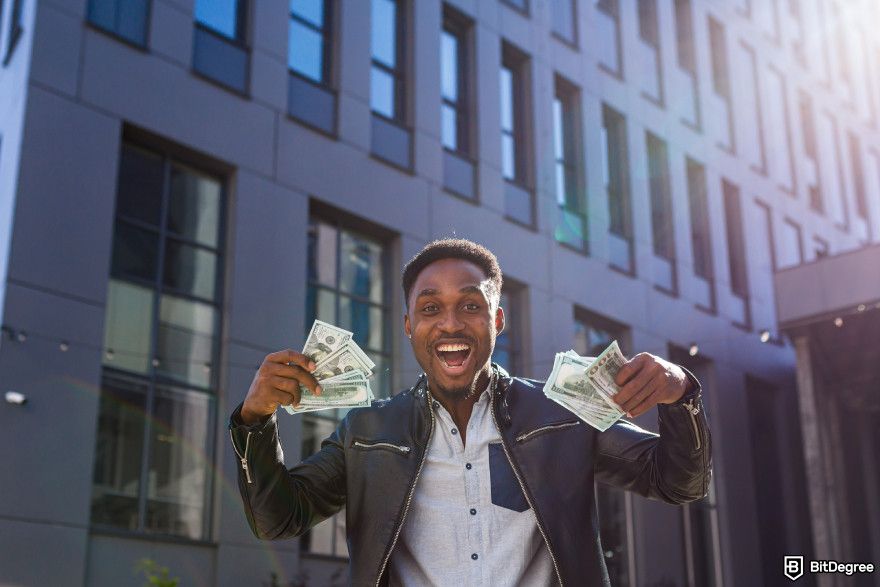 What is strategic Bitcoin reserve: a happy man holding US dollar bills.
