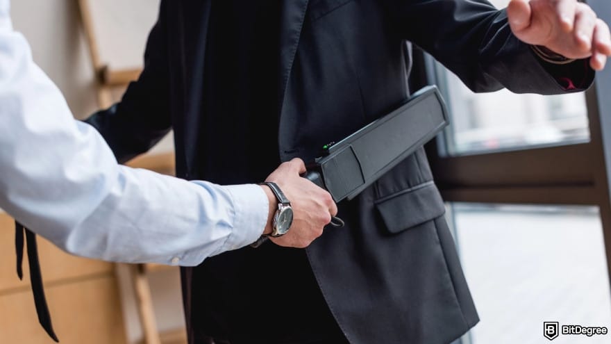White label crypto exchange: a guard using metal detector.