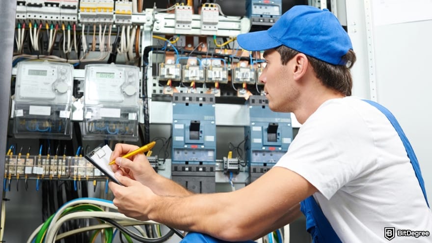 White label crypto exchange: a worker inspecting cables.