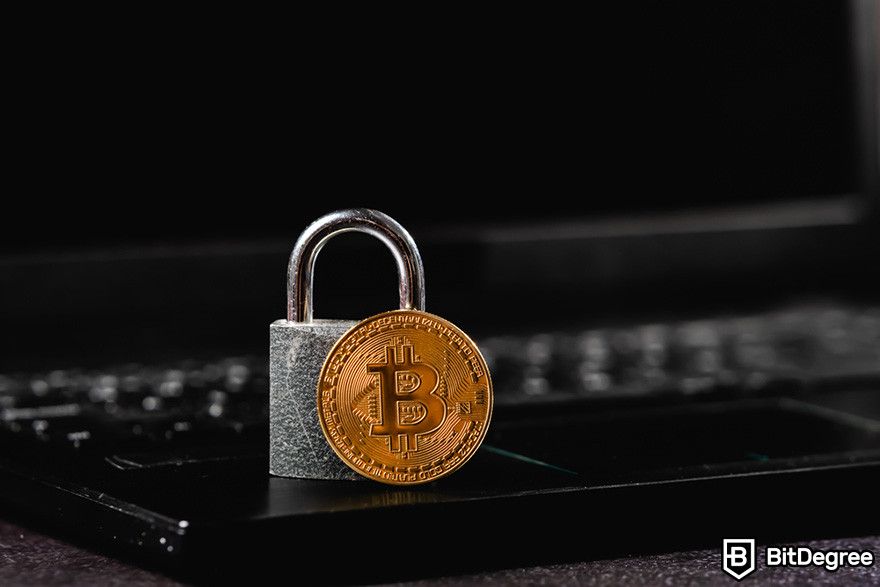 Why does crypto have value: a BTC coin and a padlock on a laptop.