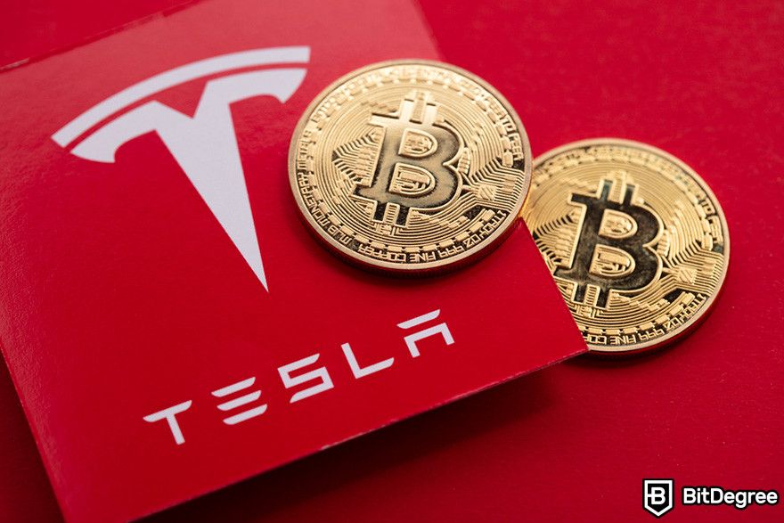 Why is crypto down: two Bitcoin coins and a red card with the Tesla logo on it.