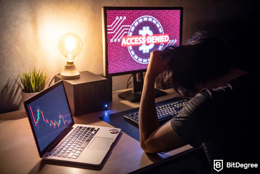 Why is crypto down: a person looking frustrated in front of a computer screen displaying the BTC logo with the text access denied.