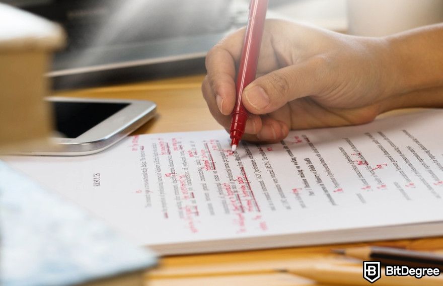 Wordtune review: A man editing on paper with a red marker.