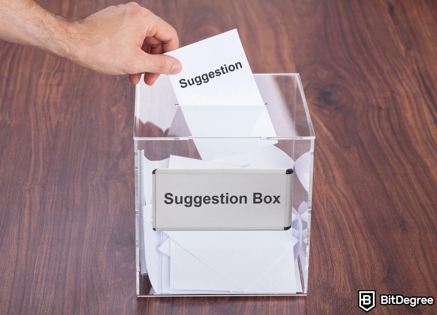 Wordtune review: A man placing a suggestion in a box.