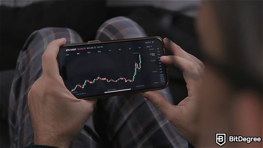 XRP staking: a man holding a phone displaying an increased stock graph.