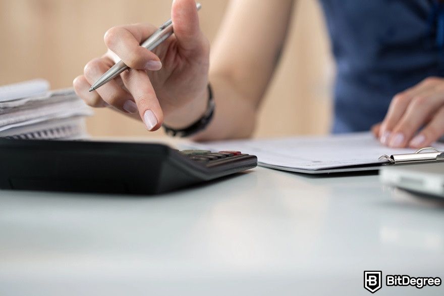 XRP staking: a close-up of woman making calculations.