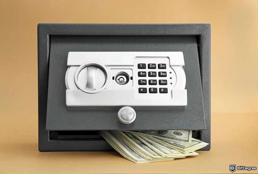 YoBit review: a small, gray safe with a keypad. The door is open, and cash is spilling out.