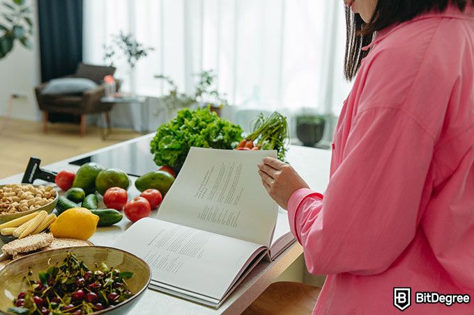 Nutrition courses online: a woman looking at a cookbook.