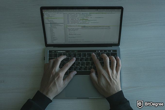 Best online coding courses: a person writing a code.