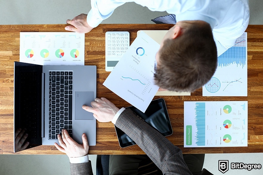 DataCamp Tableau: an overhead view of two businesspeople analyzing data.