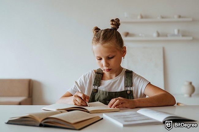 Distance Learning: a girl is taking notes.