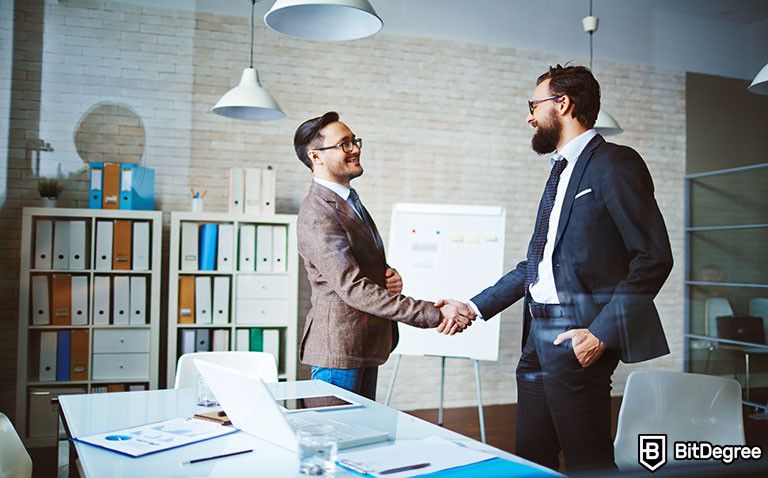 Harvard negotiation course: two businessmen shaking hands.