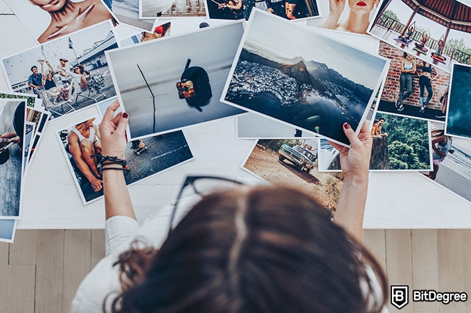 Harvard online photography course: girl looking at photographs.