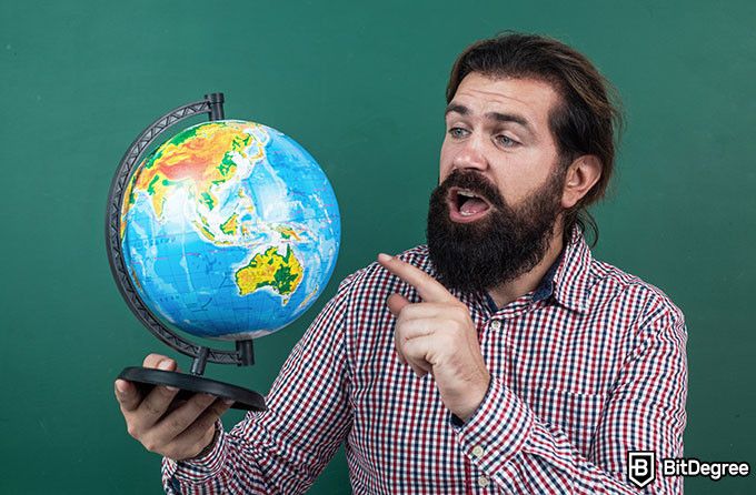 How to become a teacher: teacher with a globe