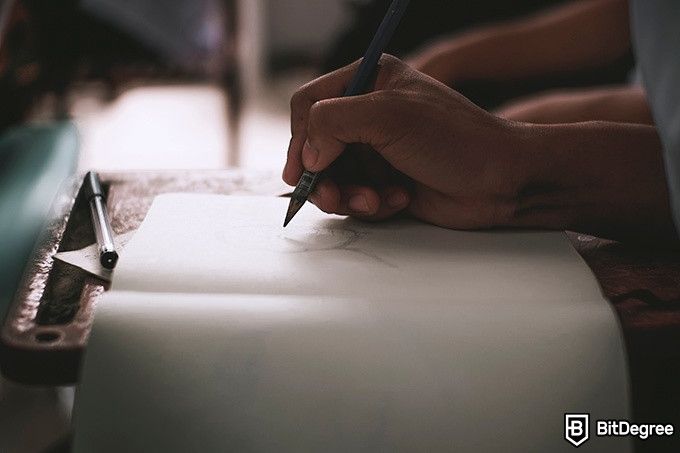 How to draw: a person is sketching in a notebook with a pencil.