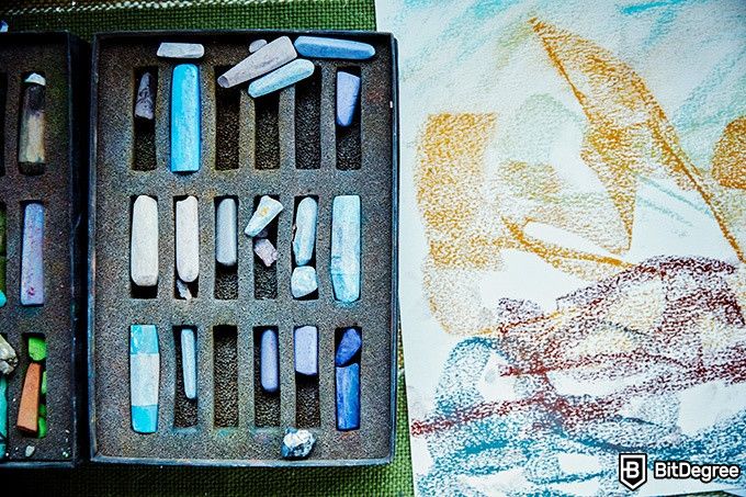 How to draw: a box of soft pastels next to a pastel drawing.