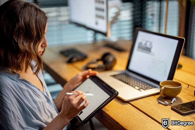 How to draw: a woman is drawing on her table.