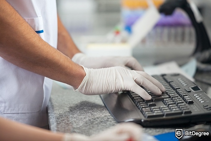 Medical Coding Classes Online - person with medical gloves using a computer.