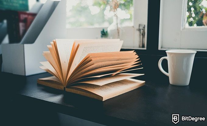 Online ethics courses: a book and a mug are on the windowsill.