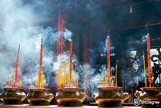 Online ethics courses: incense sticks at a temple.