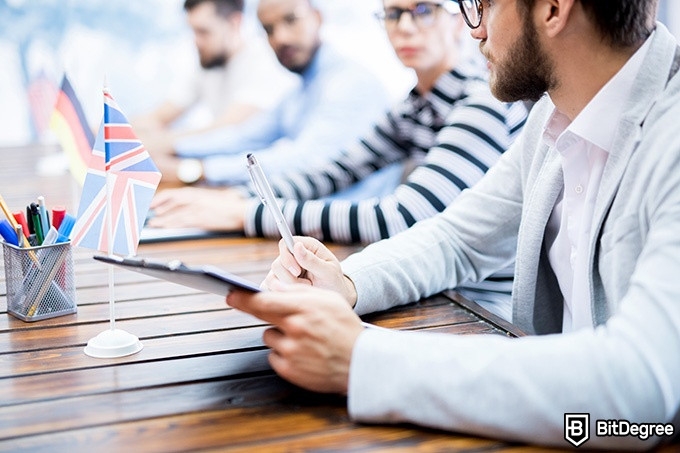 Online ethics courses: people are sitting in front of flags of different countries.