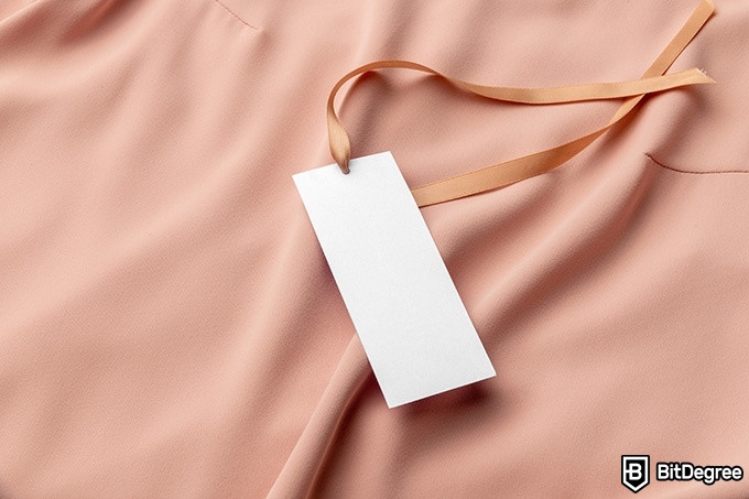 Online Fashion Design Courses: white tag on a peach background.