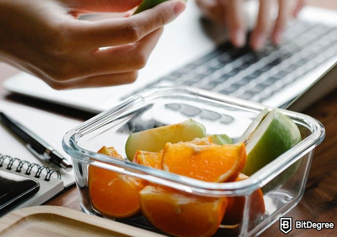 Online Healthcare Degrees: fruits placed near a laptop.