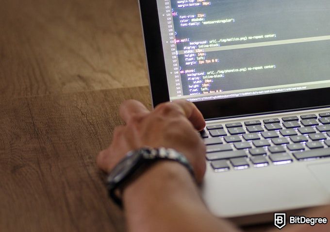 Online Healthcare Degrees: man on a laptop coding.