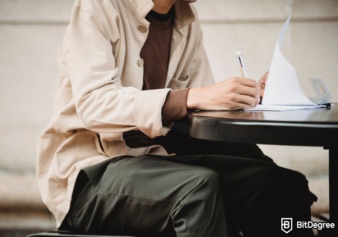 Online Healthcare Degrees: man doing an exam on paper.