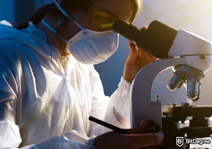 Online Healthcare Degrees: woman looking through a microscope.