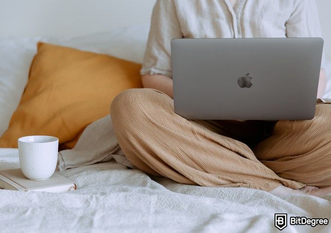 Online Healthcare Degrees: woman with a laptop in a bed.