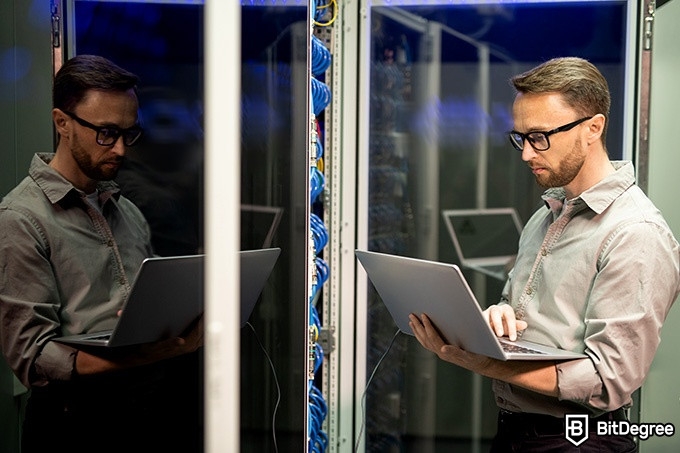 Online information technology degree: a man is performing hardware maintenance.