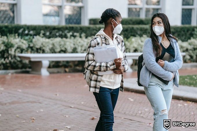 Online public health degree: two masked students in public