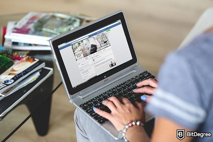 Online Social Media Courses: person logging into Facebook on their laptop.