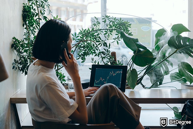 Online statistics course: a woman on her phone and looking at her computer.