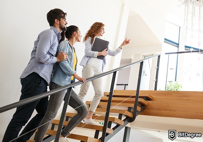 Real Estate Classes Online - realtor showing a couple the upstairs of a house.