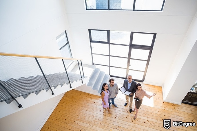 Real Estate Classes Online - couple and two realtors touring a house.