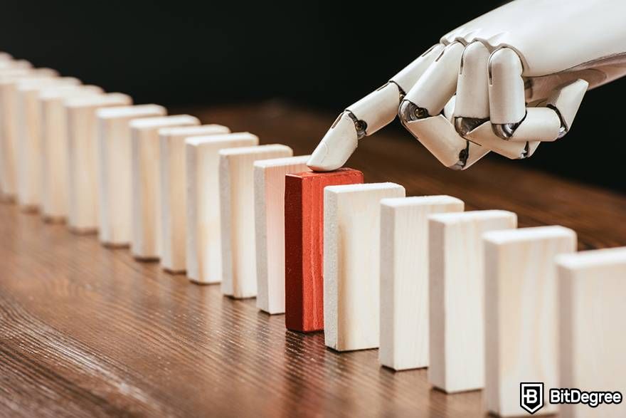 How to learn AI: A robot hand touching a red block.