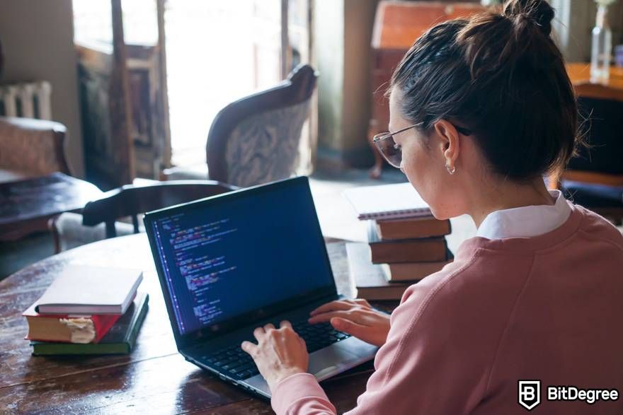 Where to learn ChatGPT: a woman is working on a coding project.